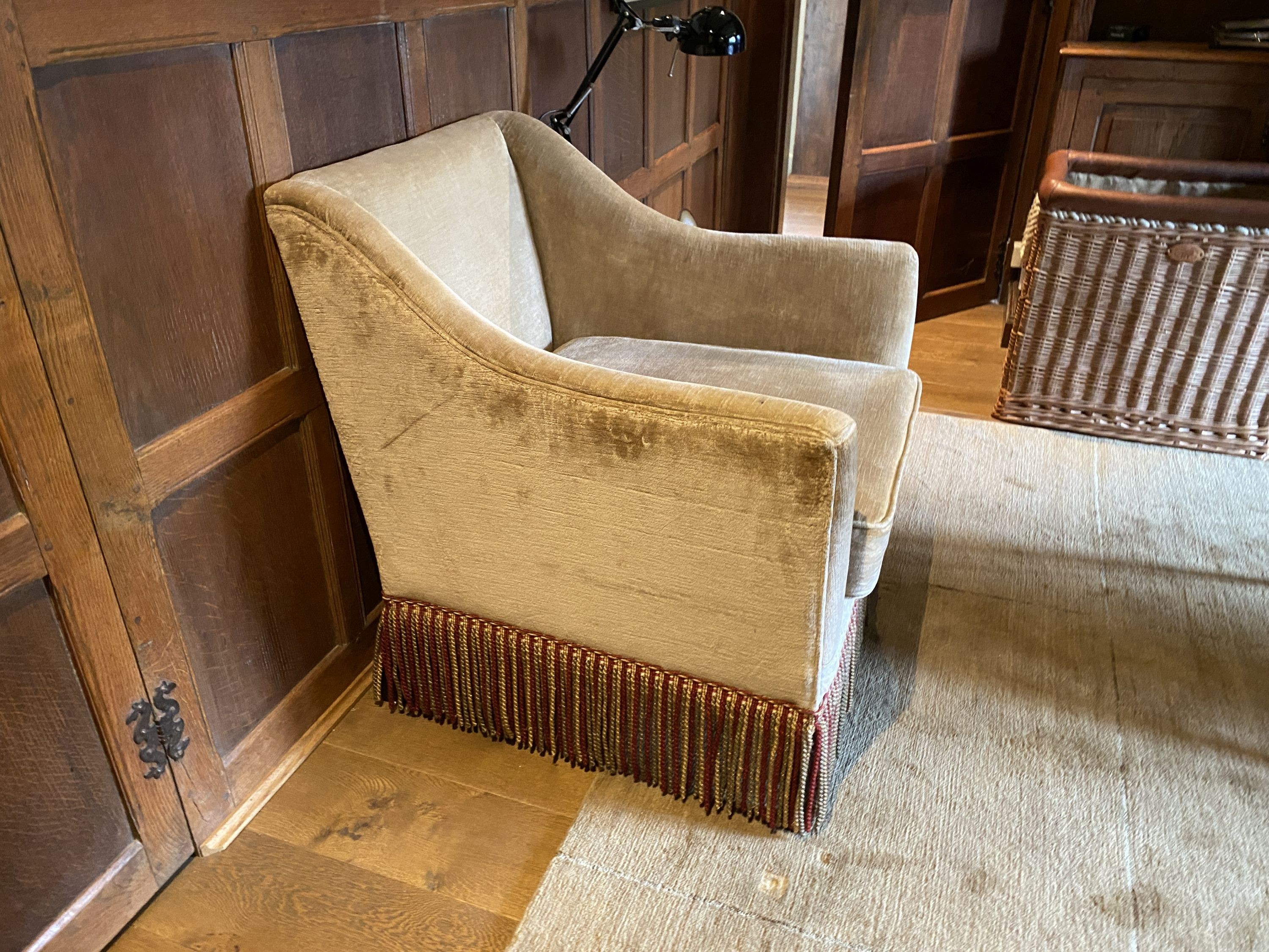 A pair of pale beige chenille armchairs, with tassle fringes, width 77cm depth 80cm